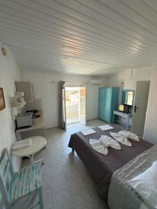 a bedroom with a large bed and a table at Blue Street Apartments in Pythagoreio