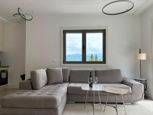 a living room with a couch and a table at Lux Studio Lustica Bay and Car in Luštica