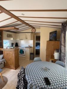 a room with a kitchen and a table in a room at Mobil home in Ambon