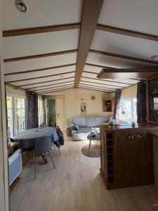 a living room with a couch and a table at Mobil home in Ambon