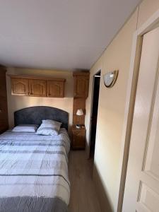 a bedroom with a bed with a blue head board at Mobil home in Ambon