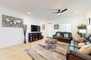 a living room with a couch and a tv at Golden Marigold Sanctuary in Buckeye