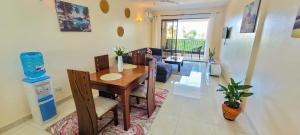 a dining room and living room with a table and chairs at Seaview homestay on Third avenue beach apt- nyali in Mombasa