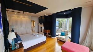 a bedroom with a large bed and a chair at Gran Room do Mar in Oya +41 photos