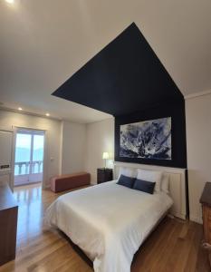 a bedroom with a large bed with a black headboard at Ocean Breeze in Oya +35 photos
