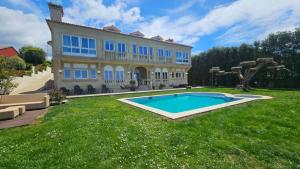 a large house with a swimming pool in the yard at Ocean Breeze in Oya