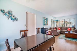a living room with a table and a couch at Morro Beach Bungalow in Morro Bay