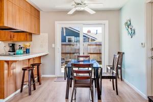a kitchen and dining room with a table and chairs at Morro Beach Bungalow in Morro Bay