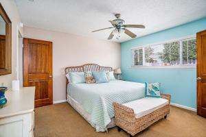 a bedroom with a bed and a ceiling fan at Morro Beach Bungalow in Morro Bay +19 photos