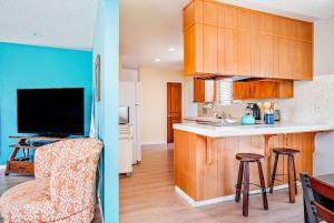 two images of a kitchen and a living room at Morro Beach Bungalow in Morro Bay
