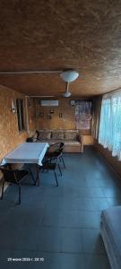 a dining room with a table and chairs in a room at ДАЧА на Студенческой in Karolino-Buhaz