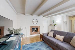 a living room with a couch and a fireplace at Sailaway Cabin A in Ventura