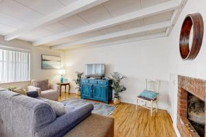 a living room with a couch and a fireplace at Sailaway Cabin A in Ventura