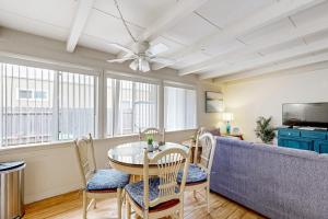 a living room with a table and chairs and a couch at Sailaway Cabin A in Ventura +23 photos