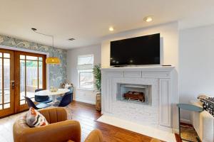 a living room with a fireplace with a flat screen tv at Dune Delight in Arroyo Grande