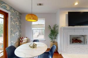 a living room with a table and chairs and a fireplace at Dune Delight in Arroyo Grande