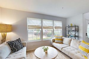 a living room with two couches and a table at Dune Delight in Arroyo Grande