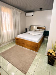 a bedroom with a bed in a room at Angico Motel in Passo Fundo