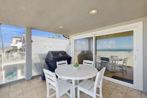 a dining room with a table and chairs on a balcony at Savor the View in Oxnard