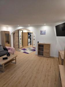 a large living room with a couch and a table at Ferienwohnung Sonneninsel in Rednitzhembach