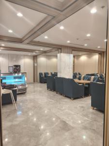 a waiting room with couches and a large aquarium at فندق لوشال LECHAL Hotel in Medina