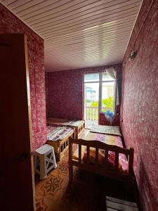 an empty room with a bed and a window at Ararat in Ozurgetʼi