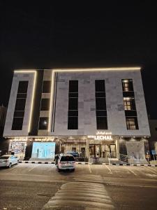a building with a car parked in front of it at فندق لوشال LECHAL Hotel in Medina