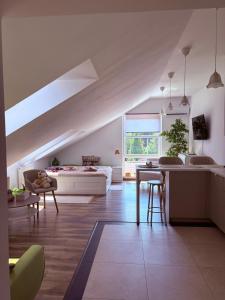 a living room with a bed and a kitchen with a table at Apartament Ptyś i Balbina w Centrum Rehabilitacji &spa in Bielsko-Biała