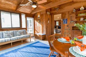 a living room with a table and a couch at Spacious Mins from Beach & Dogs Welcome in Eastham
