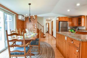 a kitchen with a table and a dining room at Spacious Mins from Beach & Dogs Welcome in Eastham