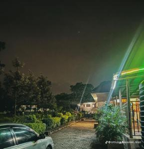 a car parked in front of a building at night at Omuka owaawe resort in Biguri