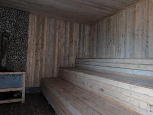 an empty wooden sauna with wooden floors and walls at Omuka owaawe resort in Biguri +1 photo