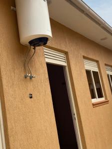 a light on the side of a house with a door at Omuka owaawe resort in Biguri