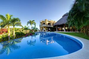 a swimming pool in front of a resort at Las Palmas Oceanfront Villas and Casitas in Santa Cruz Huatulco