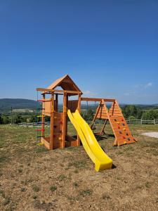 a playground with a slide and a play structure at Villa Trn in Cetingrad