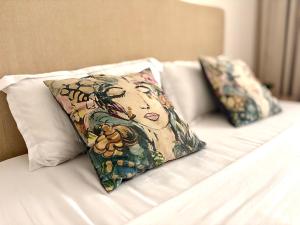 two pillows sitting on top of a bed at Polana View Apartment I in Maputo