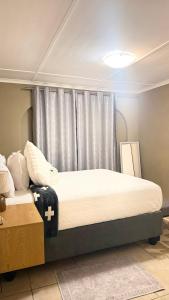 a bedroom with two beds and a window at 2 Bedrooom Self Catering Unit, East London, 5241, South Africa, KuGompo City in Dorchester Heights 