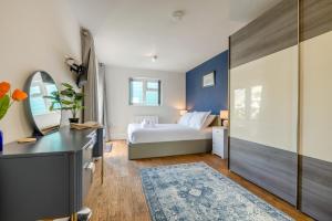 a bedroom with a bed and a desk with a mirror at 3 Bed in Tintagel oc-a36172 in Tintagel