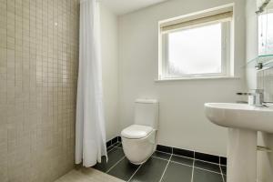 a white bathroom with a toilet and a sink at 3 Bed in Tintagel oc-a36172 in Tintagel +33 photos