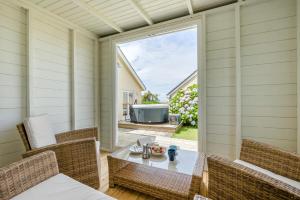 a screened porch with a table and chairs and a large window at 3 Bed in Tintagel oc-a36172 in Tintagel