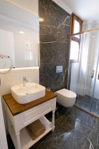 a bathroom with a sink and a toilet at Icarus Alaçatı in Çeşme