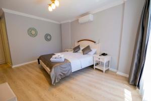 a bedroom with a bed and a table in it at Icarus Alaçatı in Çeşme