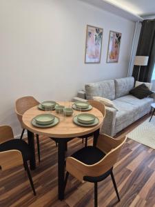 a living room with a table and a couch at Apartament przy Dworcu Sanok in Sanok