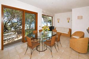 a dining room with a glass table and chairs at Casa Giannellina - Happy Rentals in Orbetello