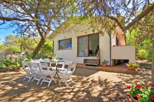 a table and chairs in front of a house at Casa Giannellina - Happy Rentals in Orbetello +36 photos