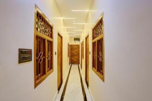 a corridor of a house with wooden doors at Hotel O SINGH GRAND HOTEL& BANQUET in Gorakhpur
