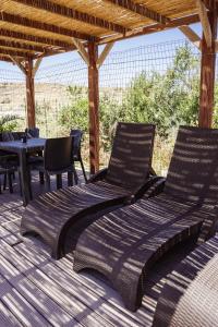 two chairs and a bed on a patio at Staytopus Kenn is Sur - Citadel Victoria Gozo Hideaway - Pool in Victoria
