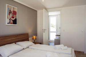 a bedroom with two beds and a painting on the wall at Staytopus Kenn is Sur - Citadel Victoria Gozo Hideaway - Pool in Victoria +60 photos