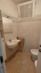 a bathroom with a sink and a toilet at Lacona Casa Franca in Lacona +18 photos