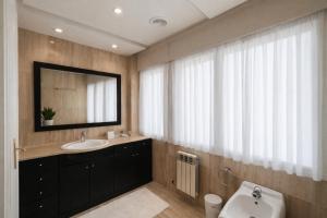 a bathroom with a sink and a mirror at LÚA Cies Room in Oya +28 photos